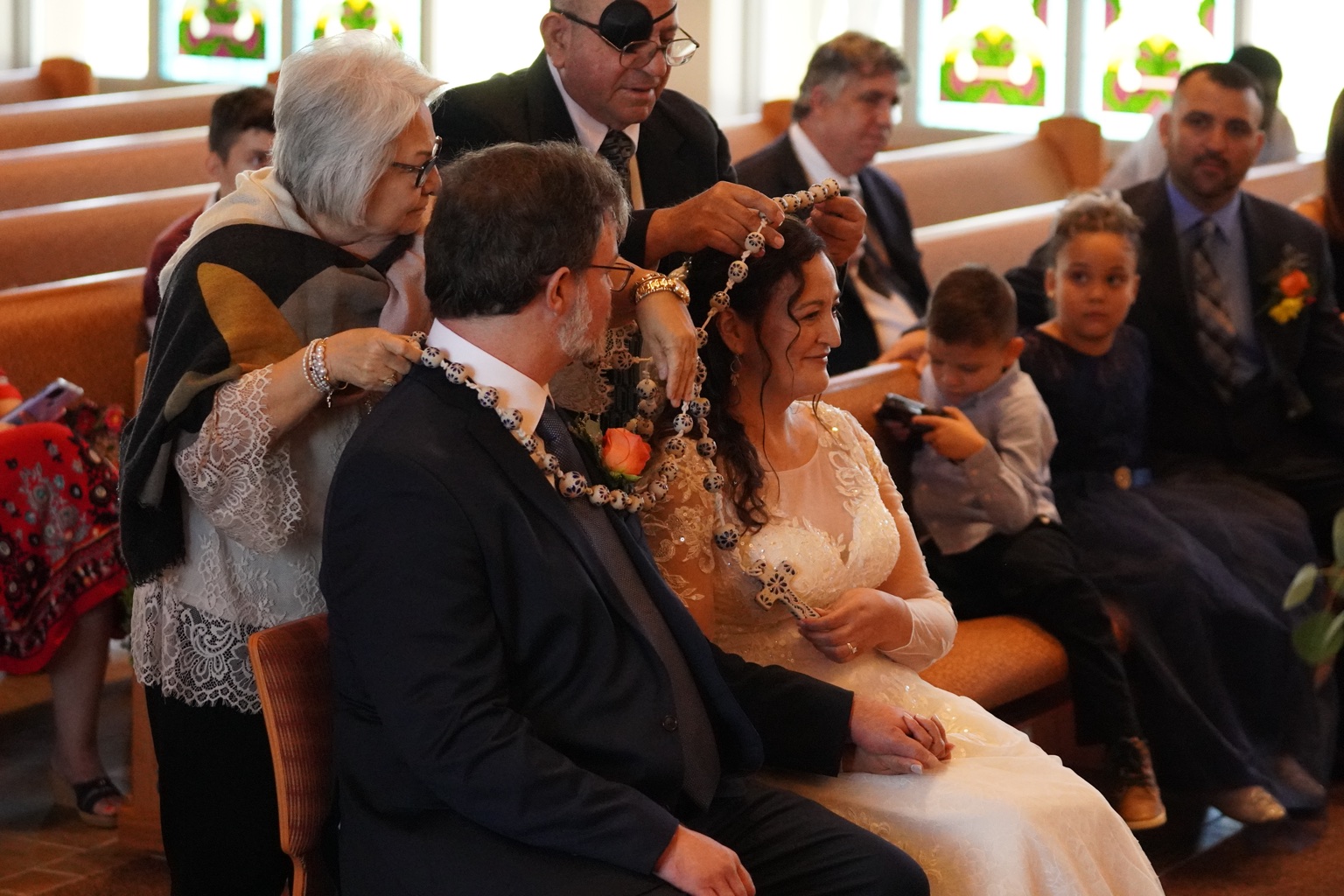 Wedding lasso placed around a couple during a Catholic wedding ceremony