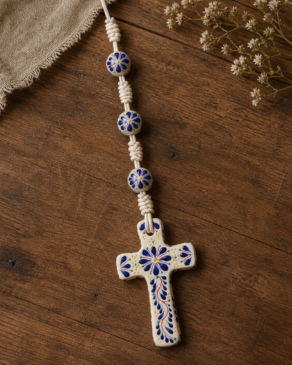 Talavera-style cross detail on a warm wood surface